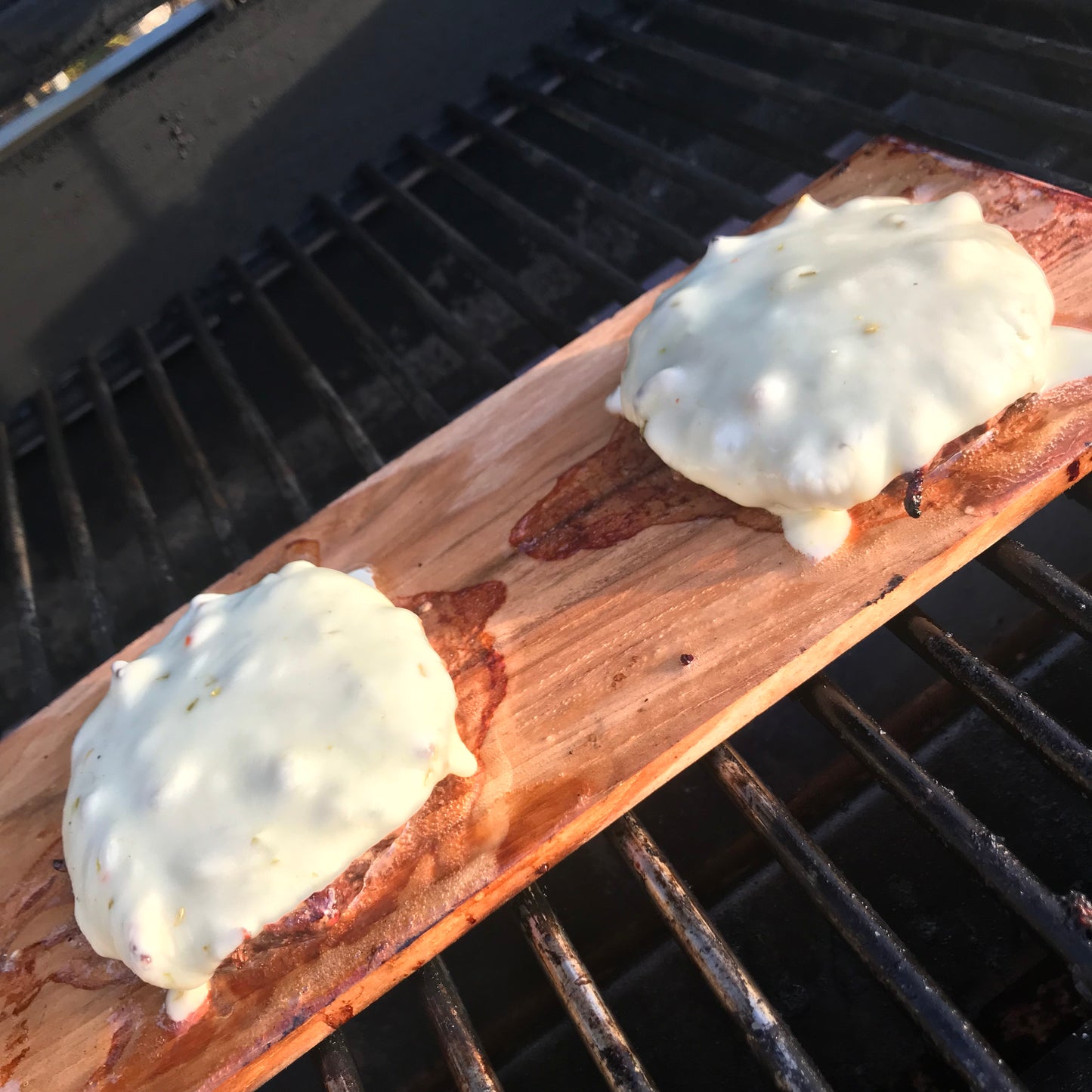 cheeseburgers on wood grilling board