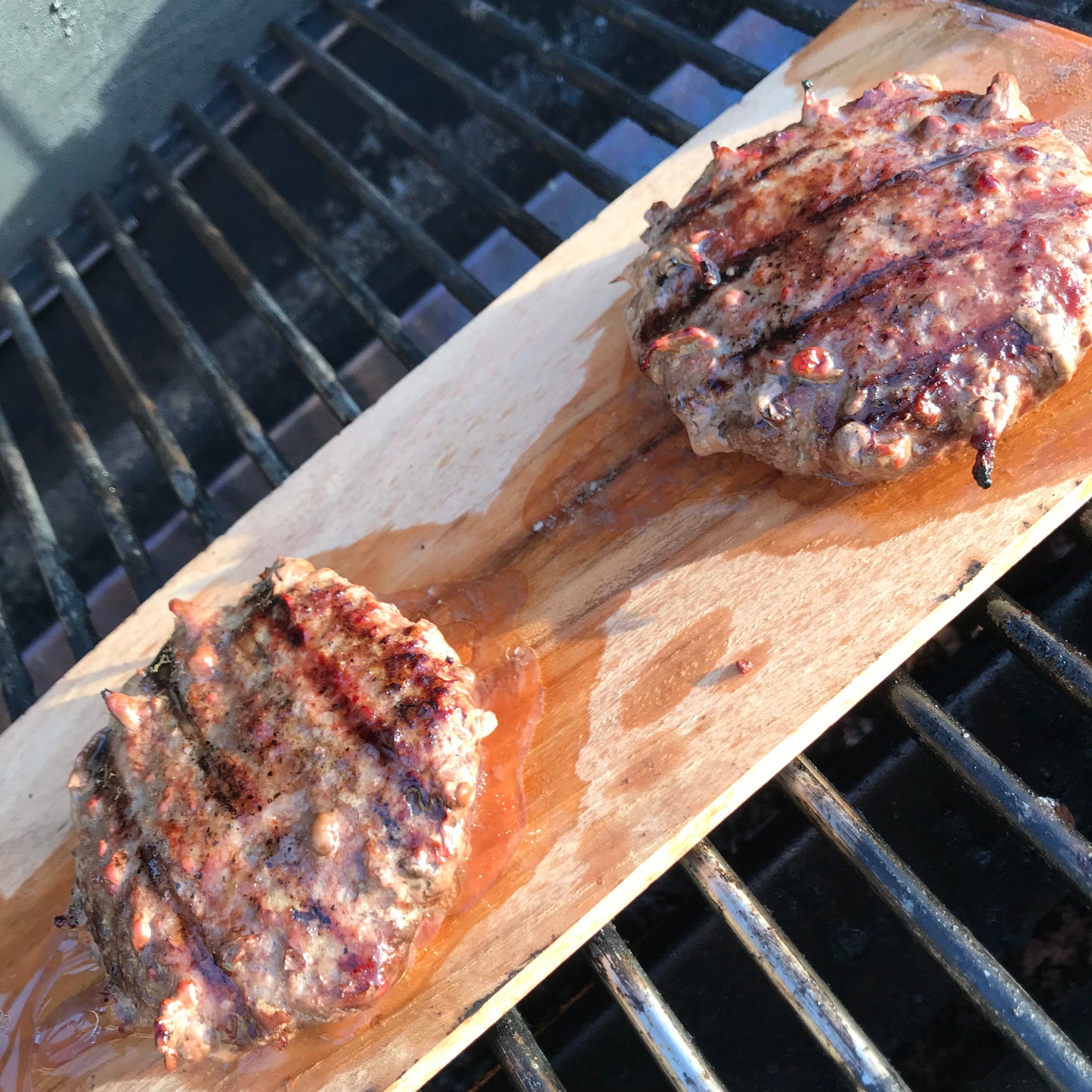 hamburgers on hickory wood grilling planks