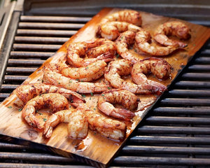 pieces of bbq shrimp on wood grilling planks